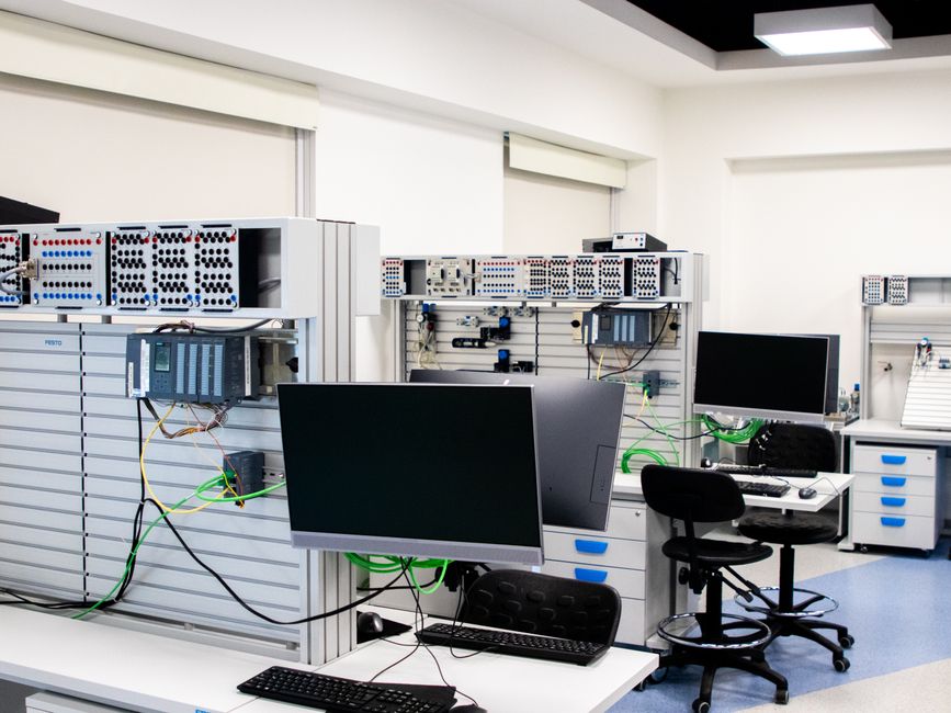 A contemporary computer lab with advanced workstations and electronic equipment